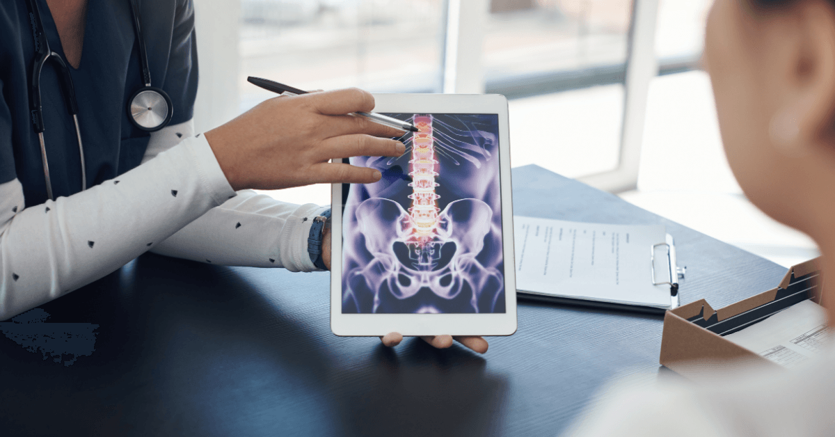 ProMed clinician reviewing a spine radiograph on a tablet